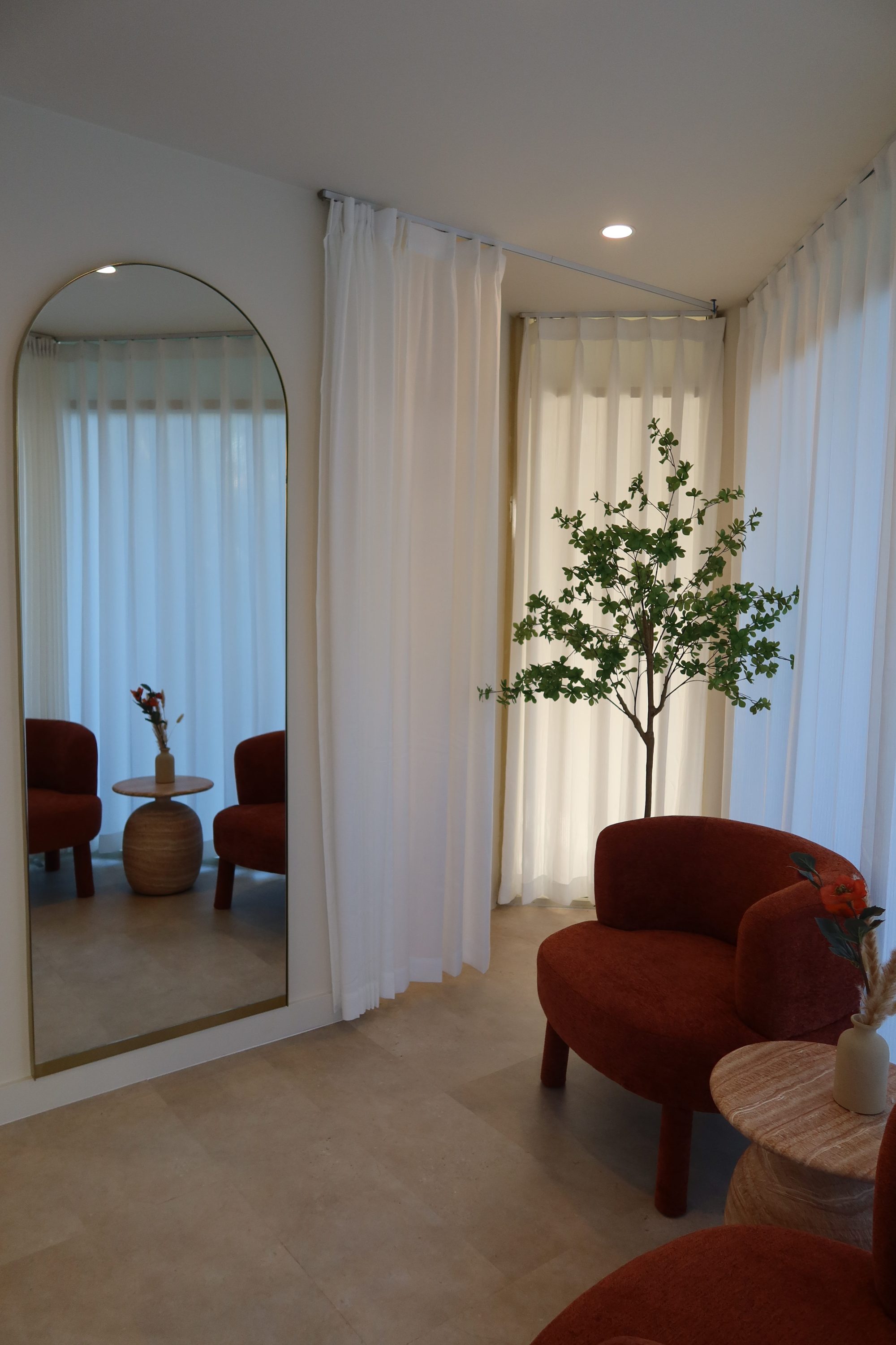 Arched mirror and styled atelier chair at Maison Montclair Narrabeen